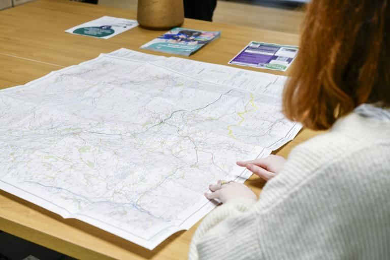 an employee looking over a map