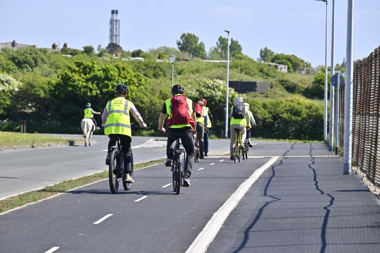 People cycling along a road