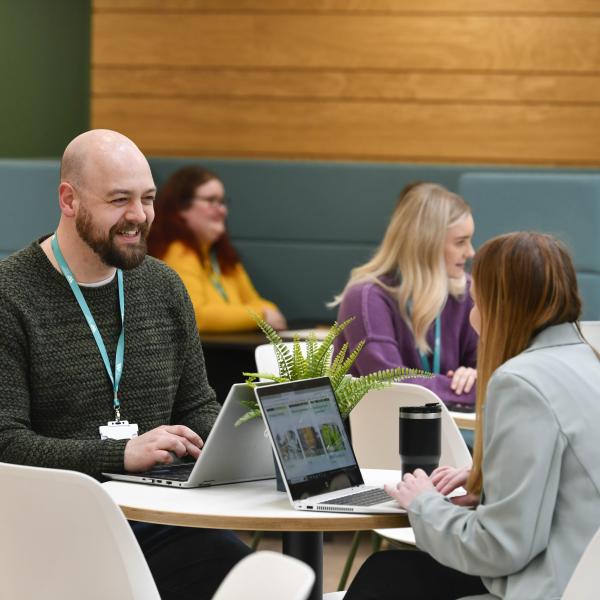 Colleagues working in an open office environment